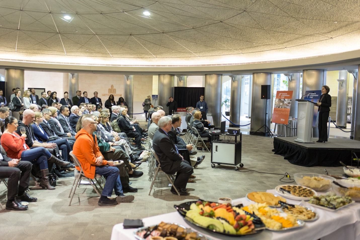 Crowd listens to Julia Langer as she launches new company