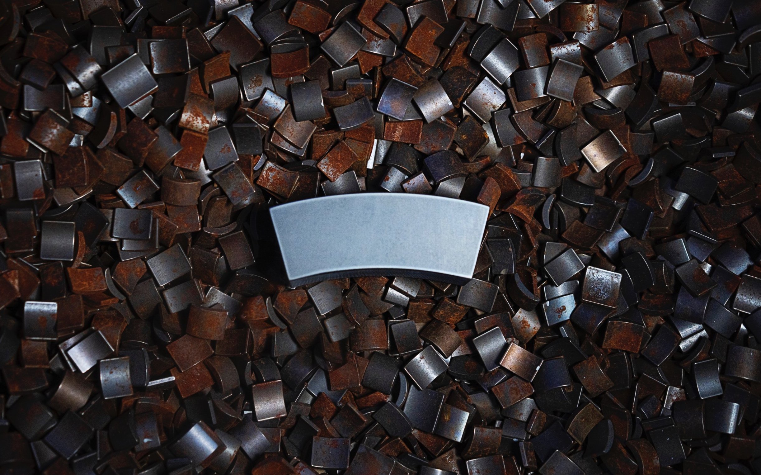 A large magnet sits atop smaller magnets