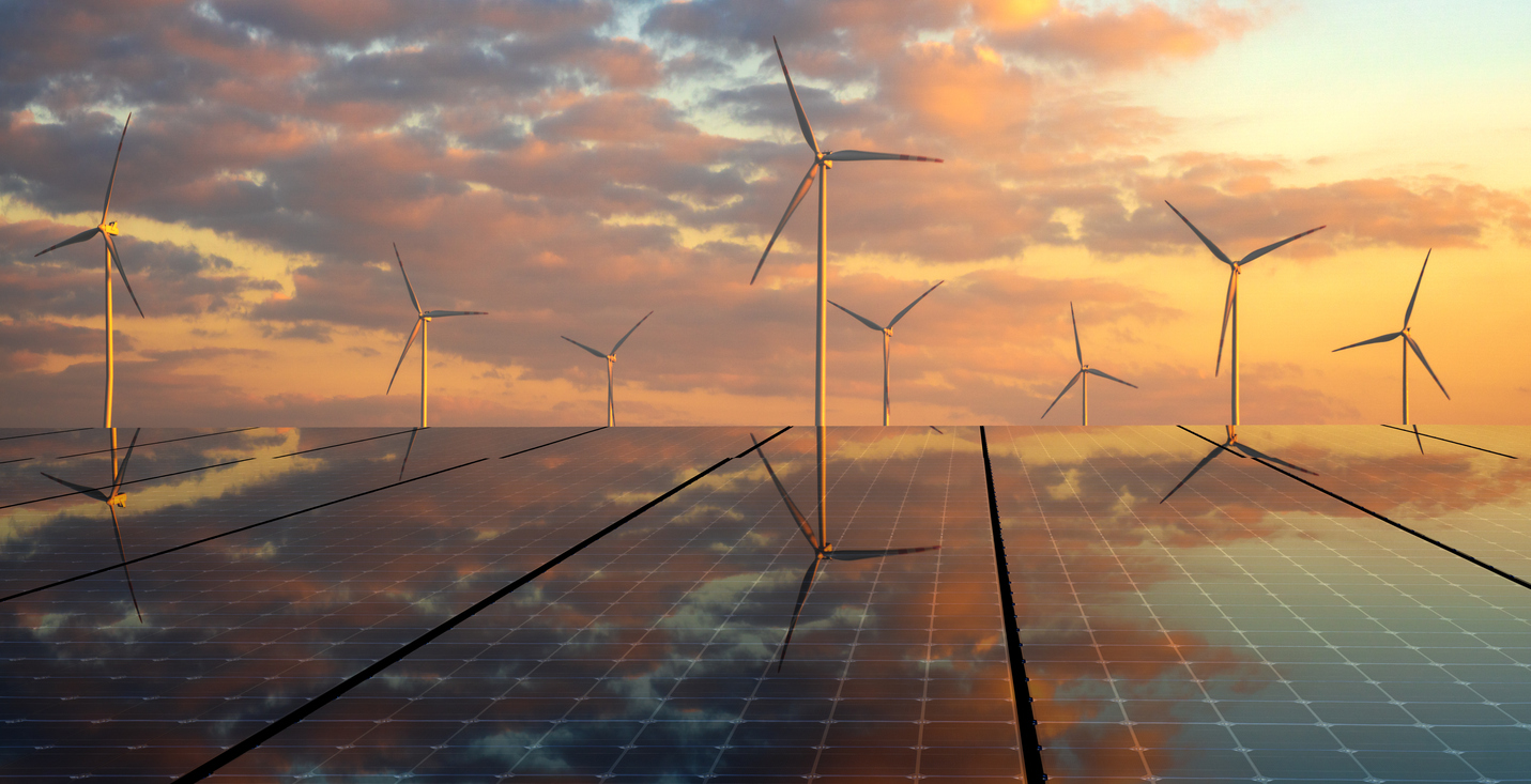 Solar panels and wind turbines at sunset