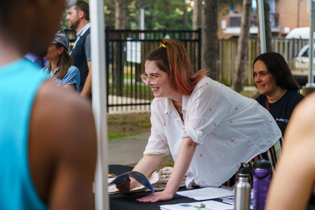 Retrofit Services Manager, Kaitlin Carroll discusses an upcoming heat pump installation with Toronto Community Housing residents. Photo by Nhan Ng Productions