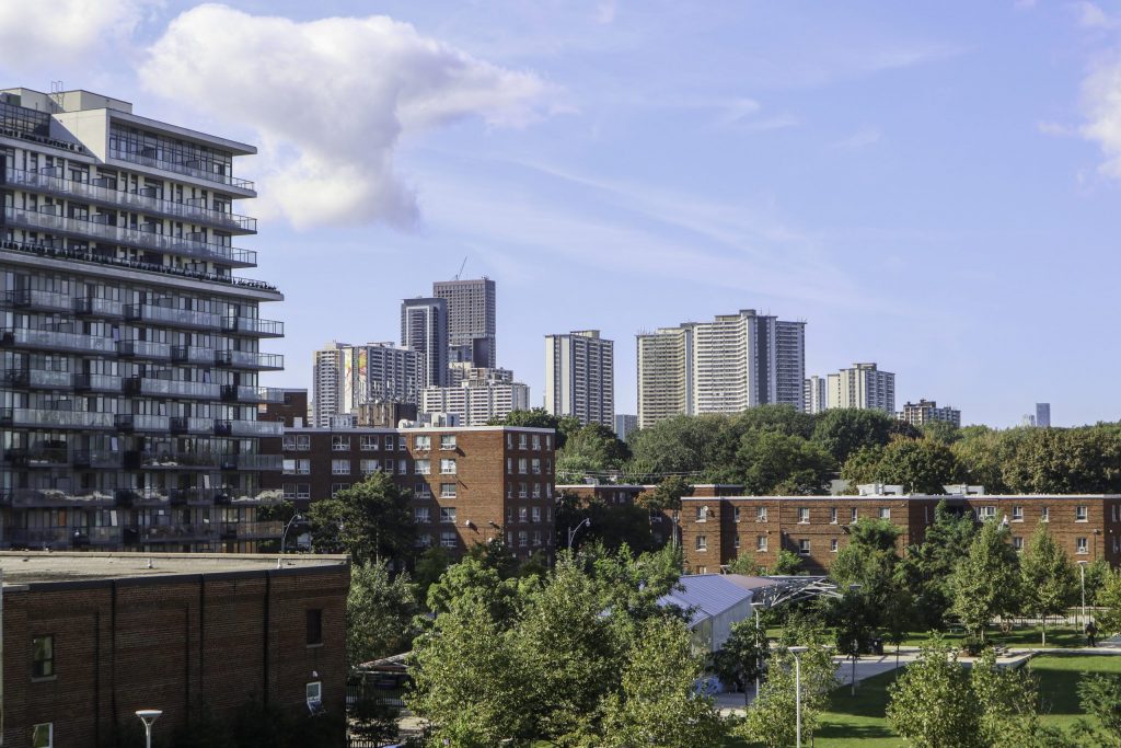 A view of Toronto. Trees are mixed in with high rise residential buildings and low rise apartments